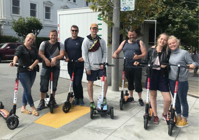 Guests with Go X scooters outside a partner hotel