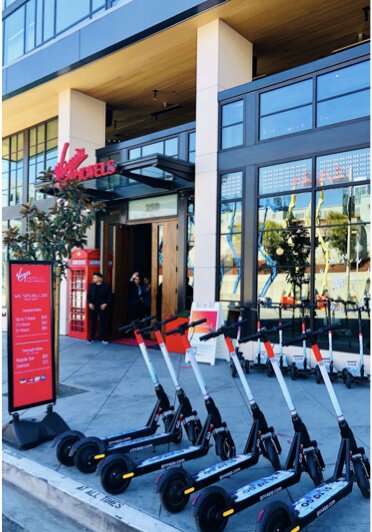 Go X scooters parked outside a Virgin Hotels partner location