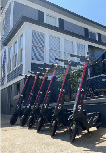 Go X scooters parked at a partner property